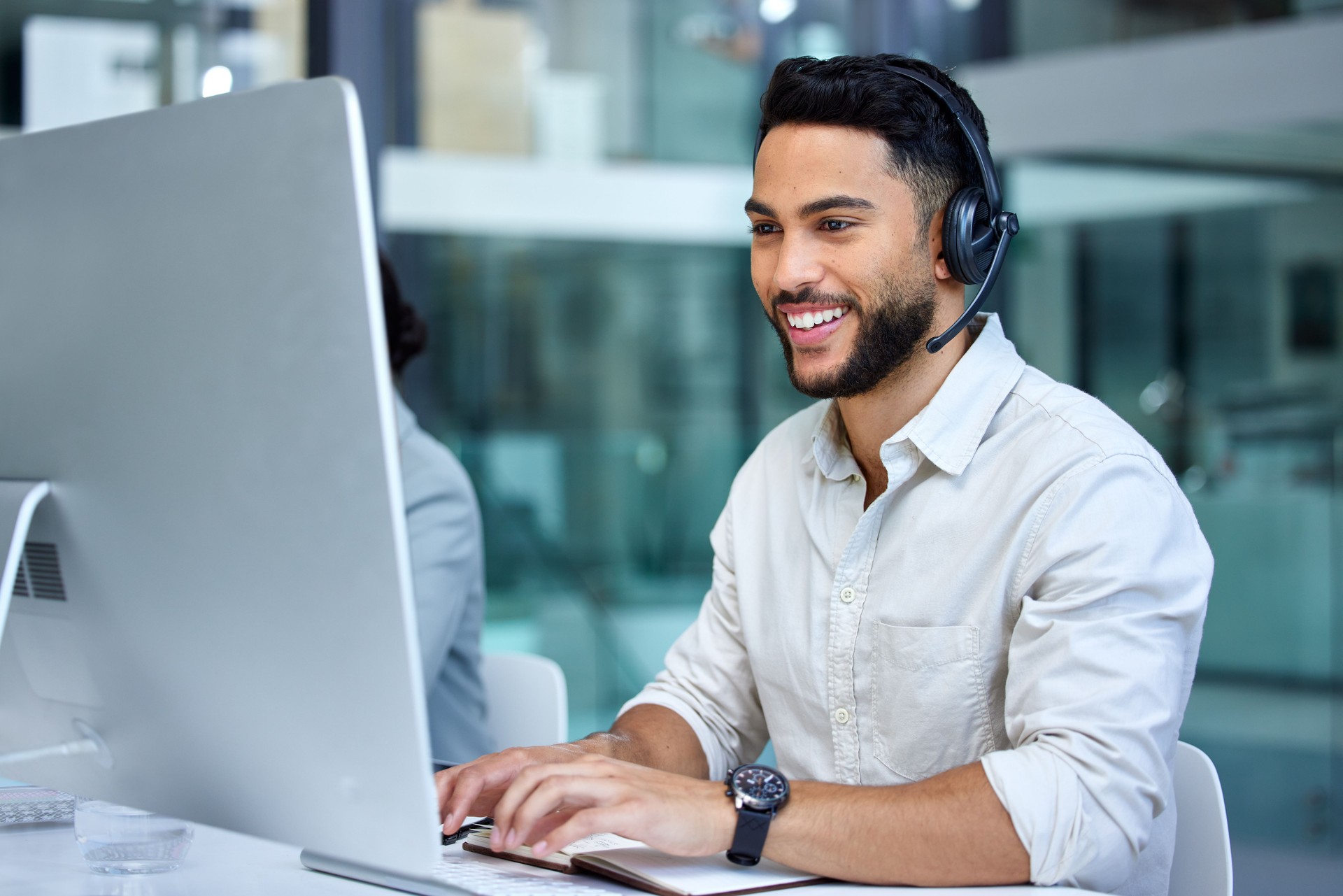 Shot of a businessman using a computer while working in a call center